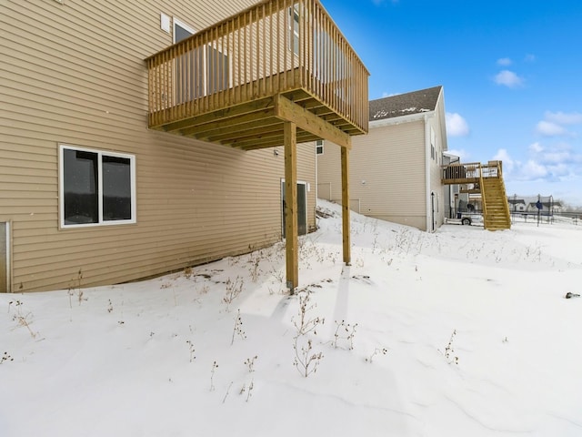 exterior space featuring a garage, cooling unit, and a wooden deck