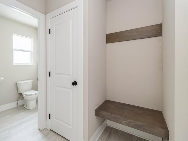 mudroom featuring light wood-type flooring and baseboards