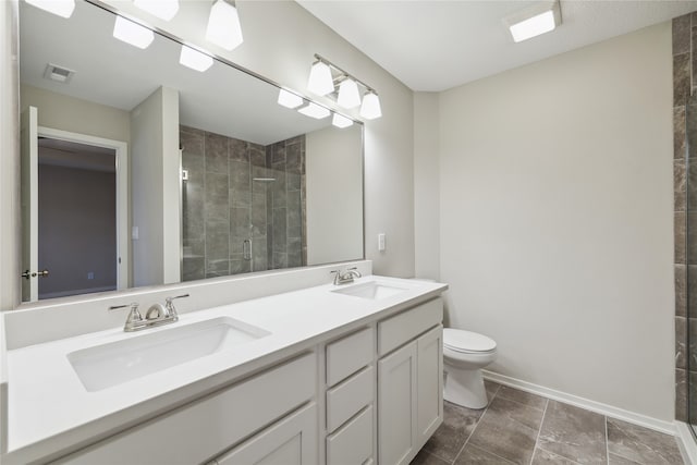 bathroom featuring walk in shower, vanity, and toilet