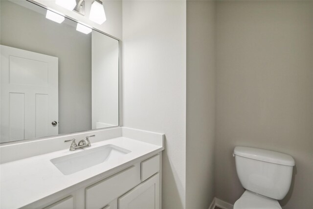 half bath with vanity and toilet