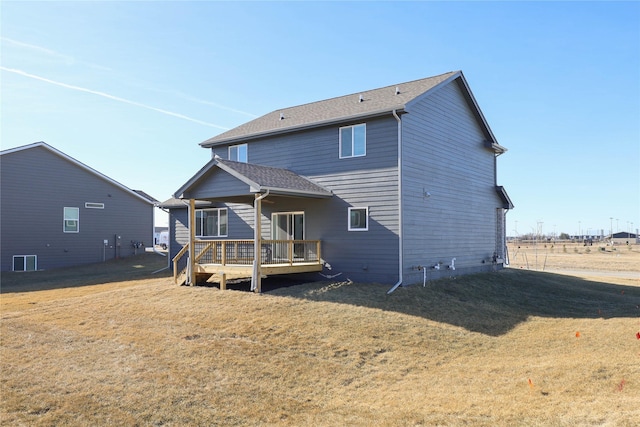 back of house with a wooden deck and a yard