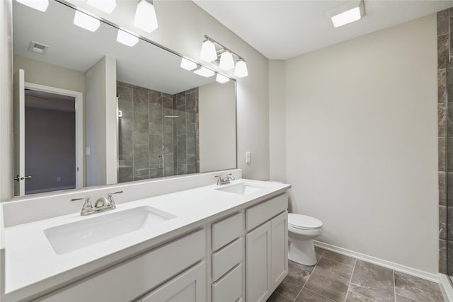 885 NW Frescott Cir, Waukee, IA 50263 - bathroom with a shower stall, toilet, baseboards, and double vanity