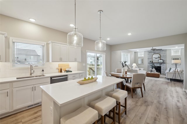 885 NW Frescott Cir, Waukee, IA 50263 - kitchen featuring a sink, stainless steel dishwasher, backsplash, a center island, and recessed lighting