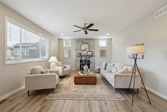 885 NW Frescott Cir, Waukee, IA 50263 - living area with ceiling fan, wood finished floors, baseboards, recessed lighting, and a fireplace
