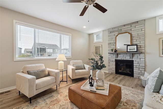 885 NW Frescott Cir, Waukee, IA 50263 - living area with a ceiling fan, wood finished floors, baseboards, a fireplace, and recessed lighting
