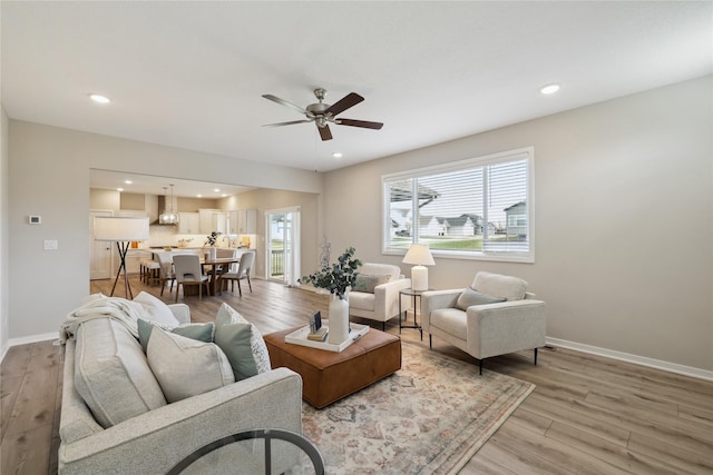 885 NW Frescott Cir, Waukee, IA 50263 - living room featuring ceiling fan, light wood-style floors, baseboards, and recessed lighting