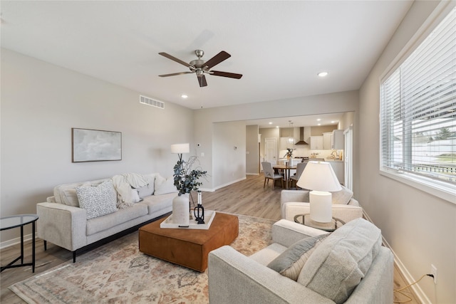 885 NW Frescott Cir, Waukee, IA 50263 - living area with light wood finished floors, baseboards, a ceiling fan, and recessed lighting