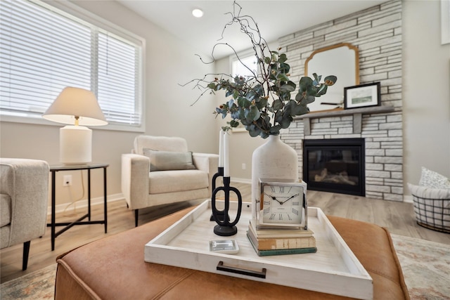 885 NW Frescott Cir, Waukee, IA 50263 - living room featuring baseboards, wood finished floors, a fireplace, and recessed lighting