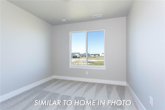 spare room featuring carpet