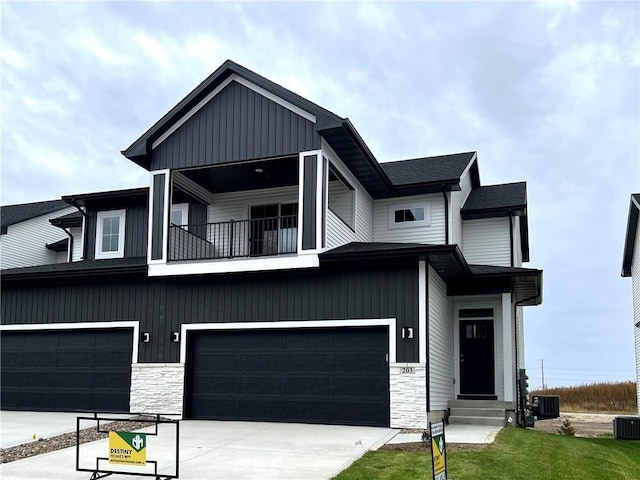 view of front facade featuring a garage and a balcony