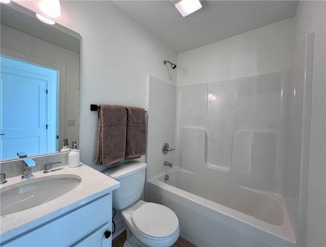 full bathroom featuring toilet, vanity, and shower / washtub combination