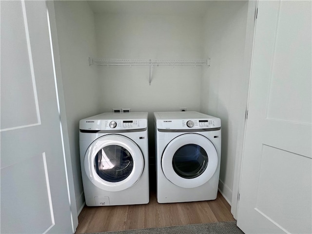 laundry room with hardwood / wood-style flooring and independent washer and dryer