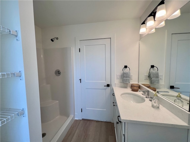 bathroom with vanity, walk in shower, and hardwood / wood-style floors