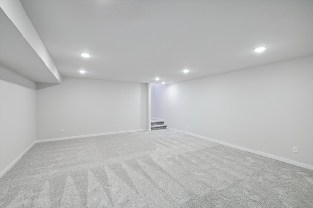 basement featuring light colored carpet