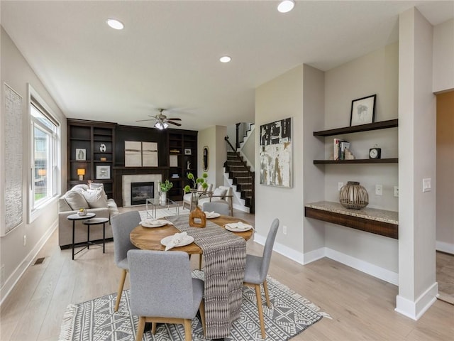 dining room with ceiling fan and light hardwood / wood-style flooring