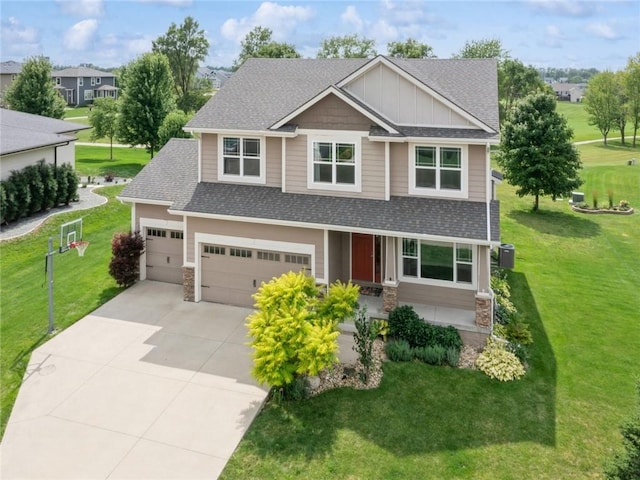 craftsman-style house featuring cooling unit, a front yard, and a garage