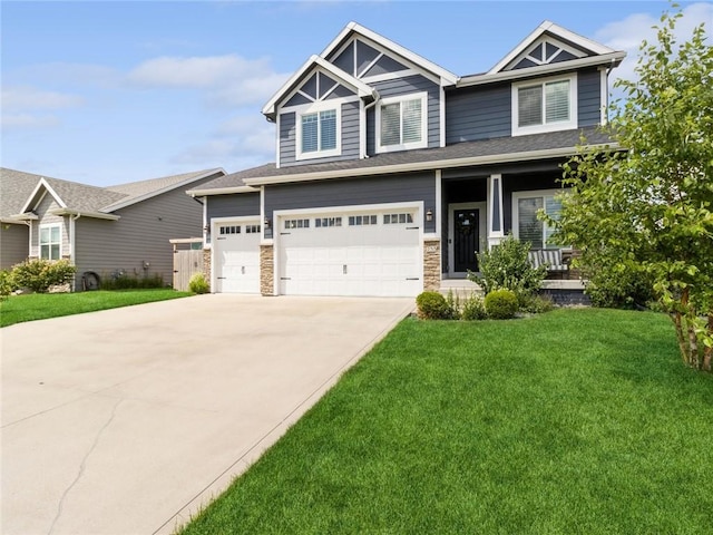 craftsman inspired home featuring a front lawn, a porch, and a garage