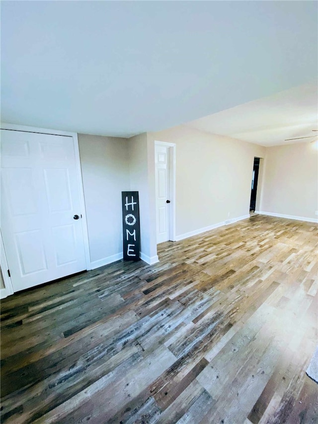 basement with dark hardwood / wood-style flooring