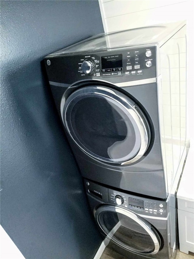 laundry room featuring stacked washer and clothes dryer