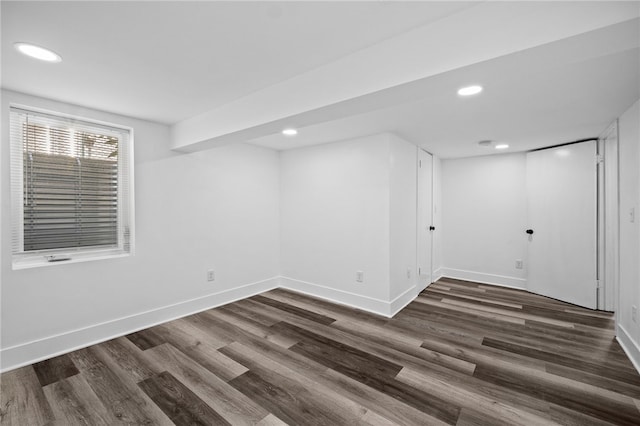 basement with dark hardwood / wood-style floors