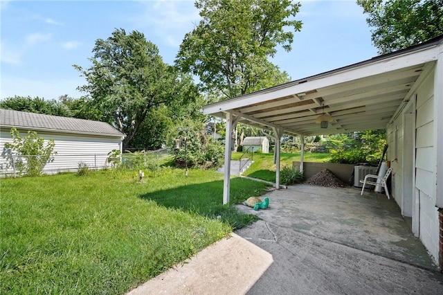 view of yard with ceiling fan and central AC unit