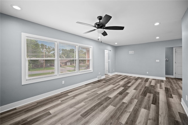 unfurnished living room featuring hardwood / wood-style flooring and ceiling fan