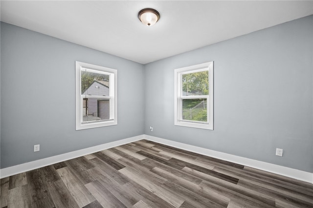 spare room featuring dark wood-type flooring