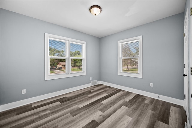 spare room featuring dark hardwood / wood-style floors