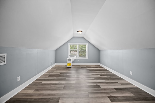 bonus room with vaulted ceiling and dark hardwood / wood-style flooring