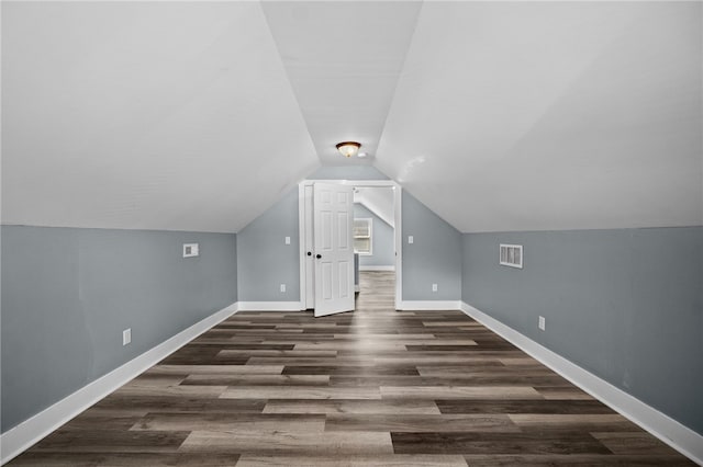 additional living space with lofted ceiling and dark hardwood / wood-style floors