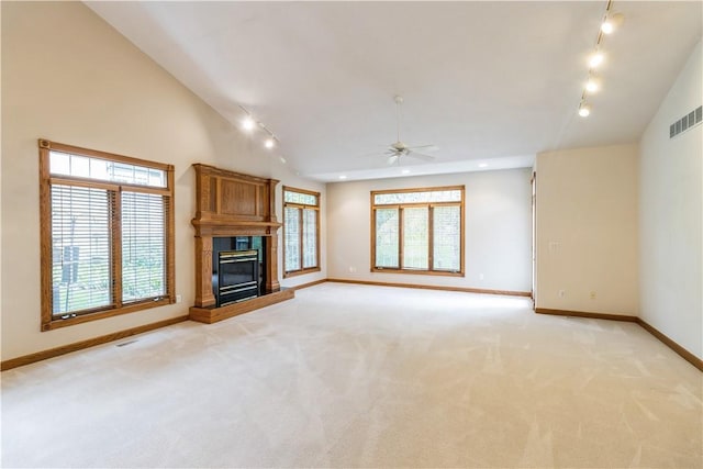 unfurnished living room featuring light carpet, vaulted ceiling, and ceiling fan