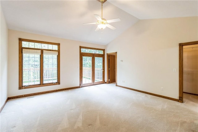 empty room with ceiling fan, french doors, light carpet, and vaulted ceiling