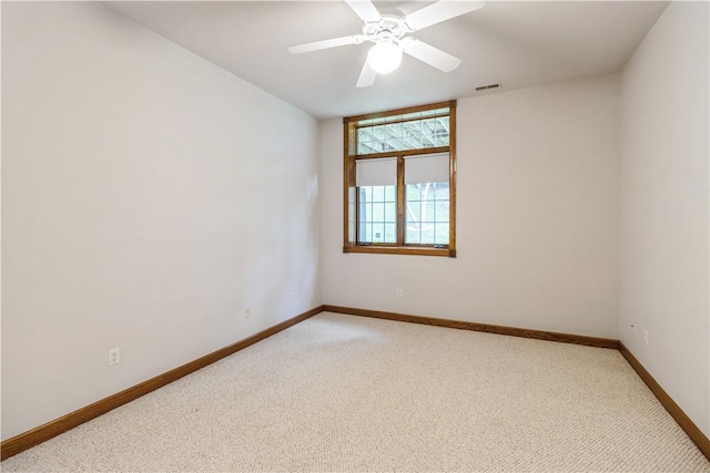 unfurnished room featuring carpet and ceiling fan