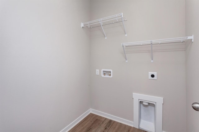 washroom with electric dryer hookup, hookup for a washing machine, and hardwood / wood-style floors