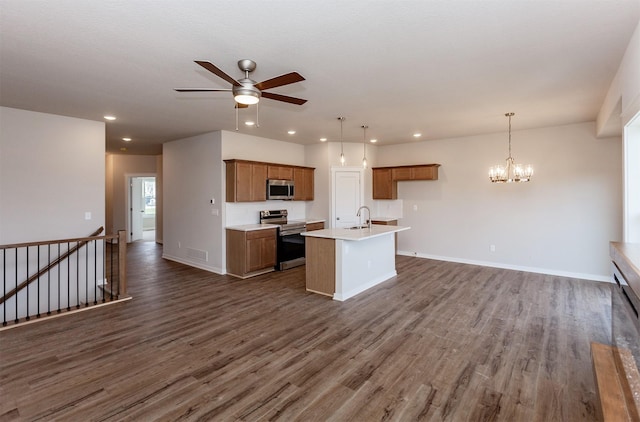 7807 SE 2nd St SE, Des Moines, IA 50320 - kitchen featuring stainless steel appliances, brown cabinets, open floor plan, dark wood finished floors, and a ceiling fan