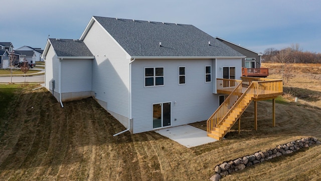 rear view of house with a lawn and a wooden deck