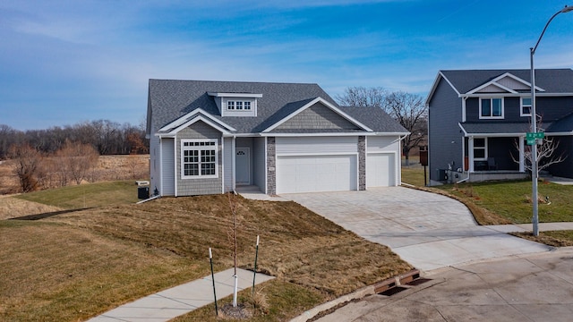 7807 SE 2nd St SE, Des Moines, IA 50320 - view of front of home with a garage, driveway, a front lawn, and covered porch