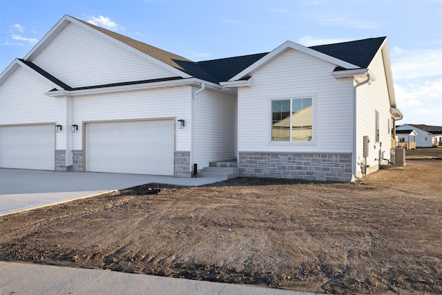 view of front facade featuring central AC and a garage