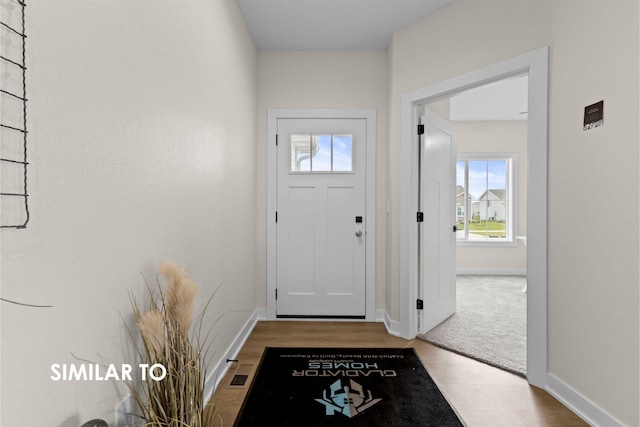 entryway with light colored carpet