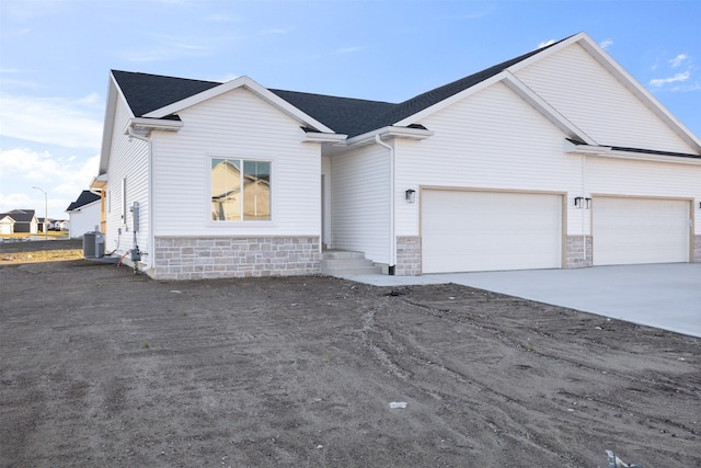 view of front of house with cooling unit and a garage