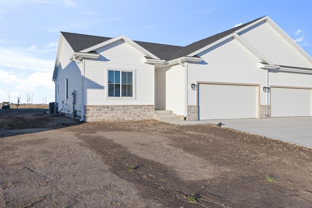 view of front facade with central AC unit and a garage