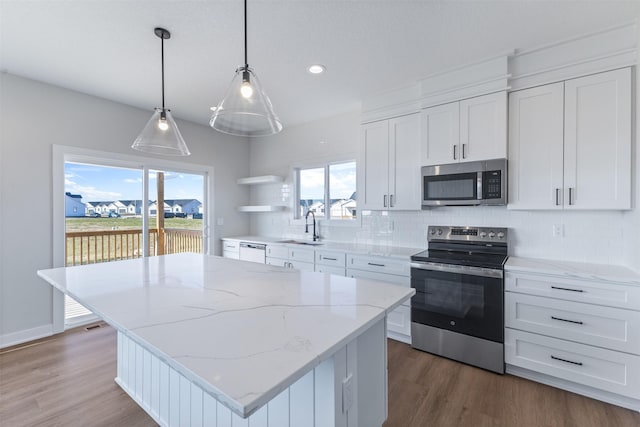 kitchen featuring a kitchen island, white cabinetry, and appliances with stainless steel finishes