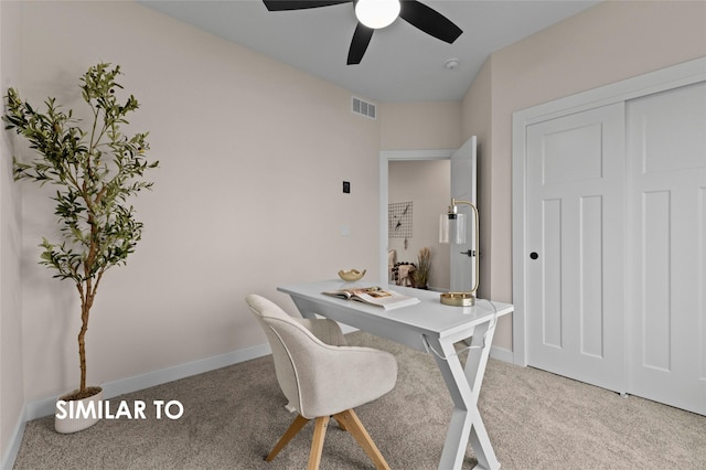 carpeted home office featuring ceiling fan