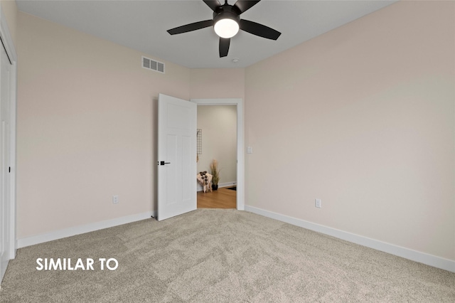 unfurnished bedroom featuring light colored carpet and ceiling fan