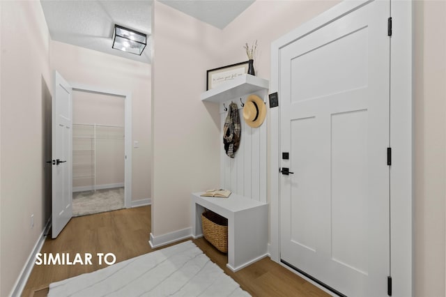 mudroom featuring a textured ceiling and light wood-type flooring