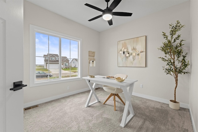 carpeted home office with ceiling fan