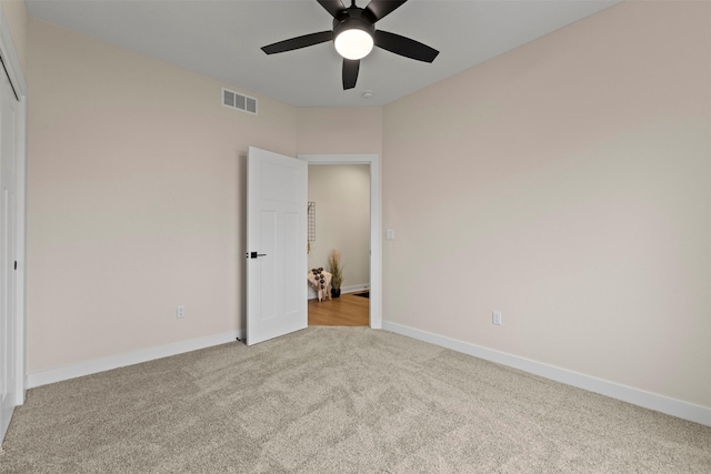 unfurnished bedroom featuring light carpet and ceiling fan