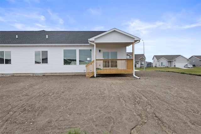 back of house featuring a wooden deck