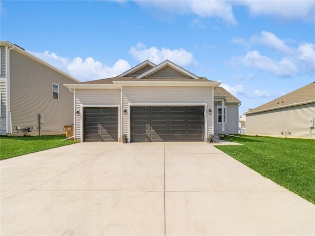 view of front of house with a front lawn, an attached garage, and driveway