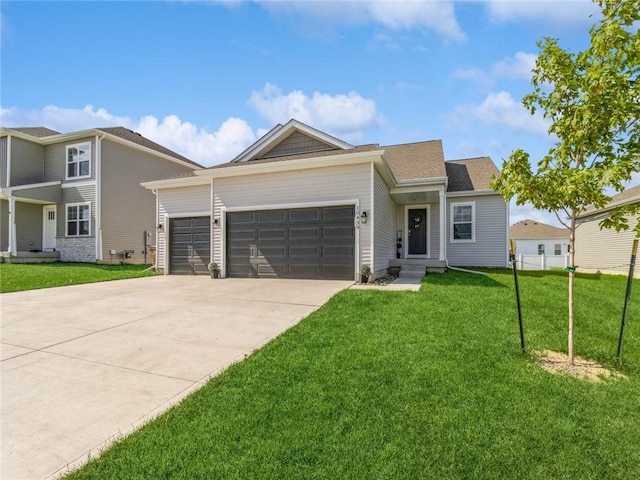 view of front of home featuring a front yard, concrete driveway, and a garage